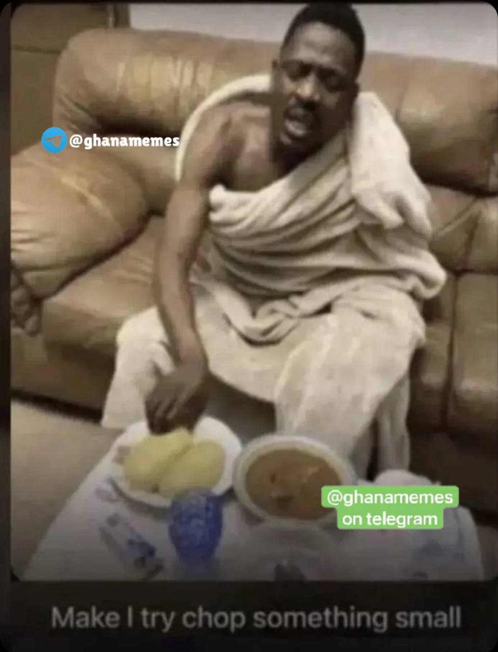 a man sitting on a couch with a bowl of food